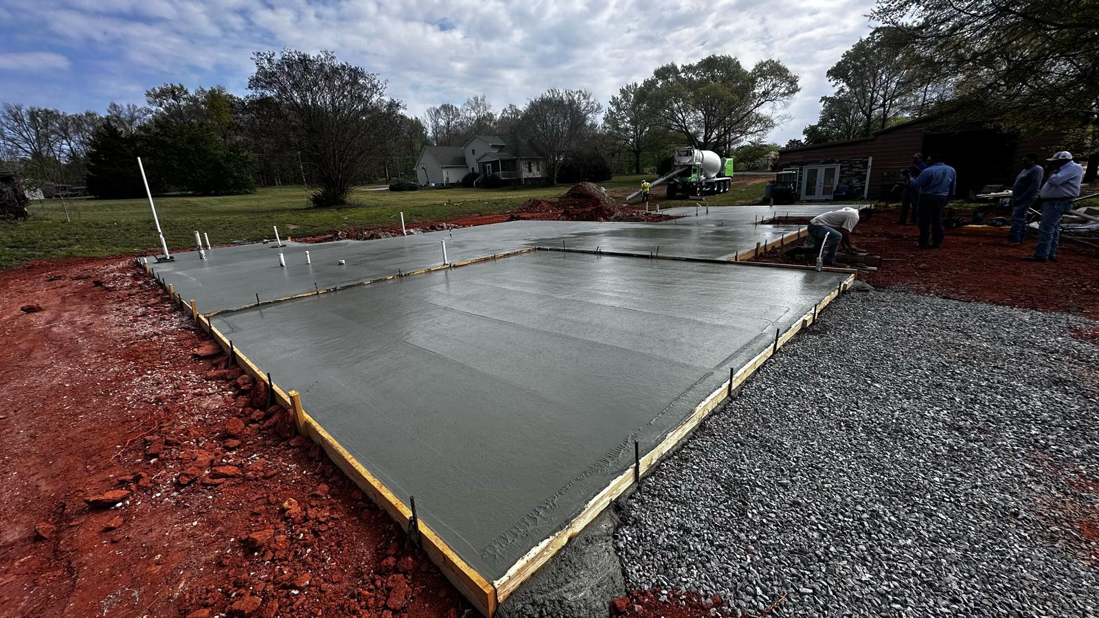 Freshly poured footings and foundation walls in excavated site
