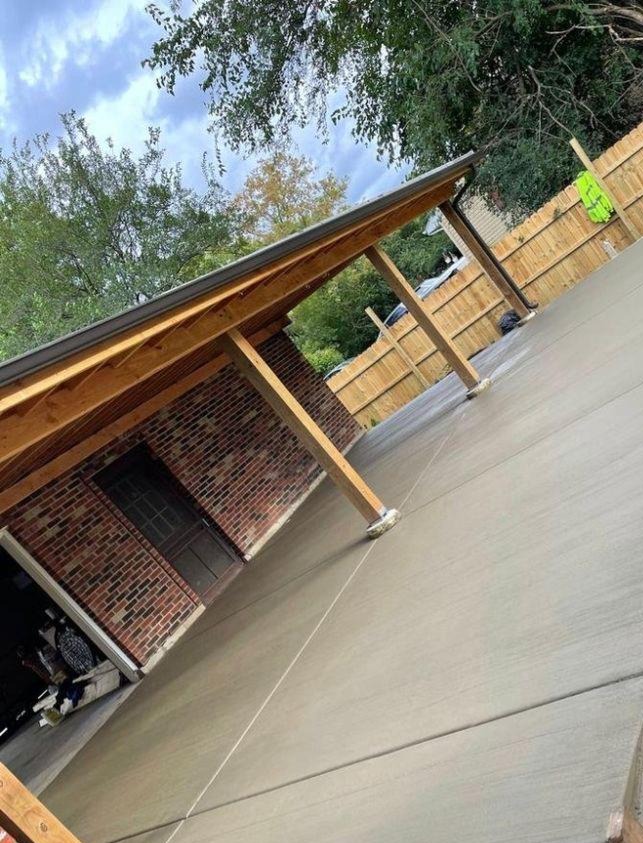 Freshly poured concrete patio with covered pergola